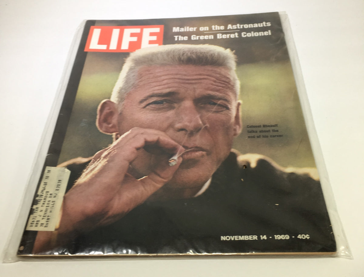Vintage Life Magazine cover from November 14, 1969, featuring Colonel Robert Rheault, an ex-Green Beret, depicted with a cigarette, showcasing the magazine's title 'LIFE' prominently, capturing the essence of the 1960s.