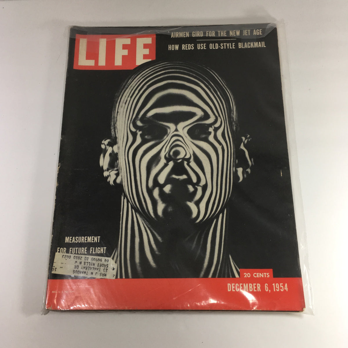 Vintage Life Magazine from December 6, 1954 featuring measurement for future flight and the Jet Man Age on the cover, showcasing an artistic black and white design with a man’s face.