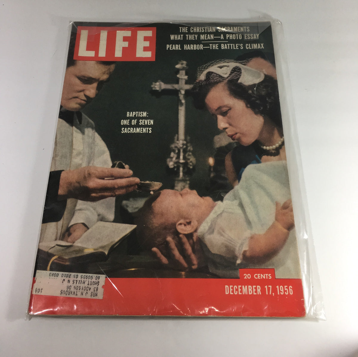 Cover of Life Magazine from December 17, 1956, featuring an article on Baptism as one of the seven Christian sacraments. The image depicts a ceremony with a baby, highlighting the significance of Baptism, along with the magazine's iconic red logo.