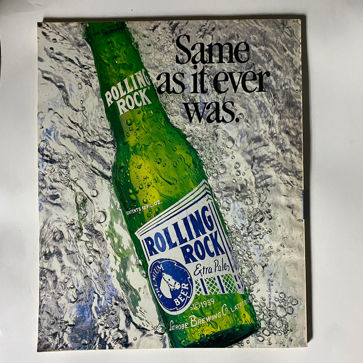 Cover of Dick Vitale's College Basketball Magazine 1993-1994 showcasing a Rolling Rock beer advertisement with the phrase 'Same as it ever was' alongside a vividly illustrated beer bottle, reflecting the nostalgic aesthetic of the era.