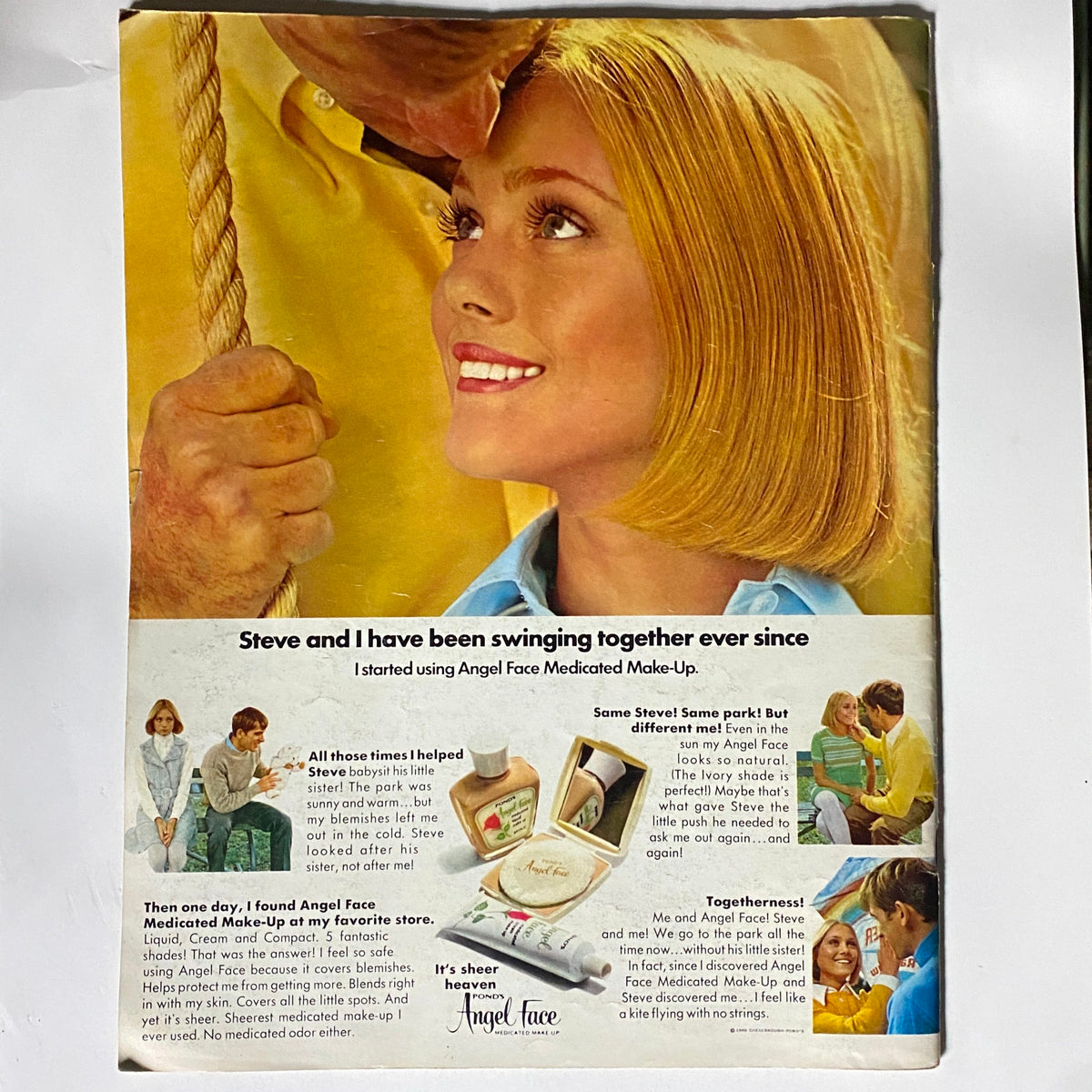 Vintage advertisement featuring Angel Face Medicated Make-Up, showcasing a smiling woman with a bob hairstyle, her expression reflecting joy and confidence. Accompanied by a man holding a rope, the ad emphasizes the product's benefits for blemish cover-up, appealing to those interested in beauty solutions in the nostalgic context of March 1969 and referencing the title 'VTG Eye Magazine March 1969 Bill Graham The P.T. Barnum of Rock n' Roll'.