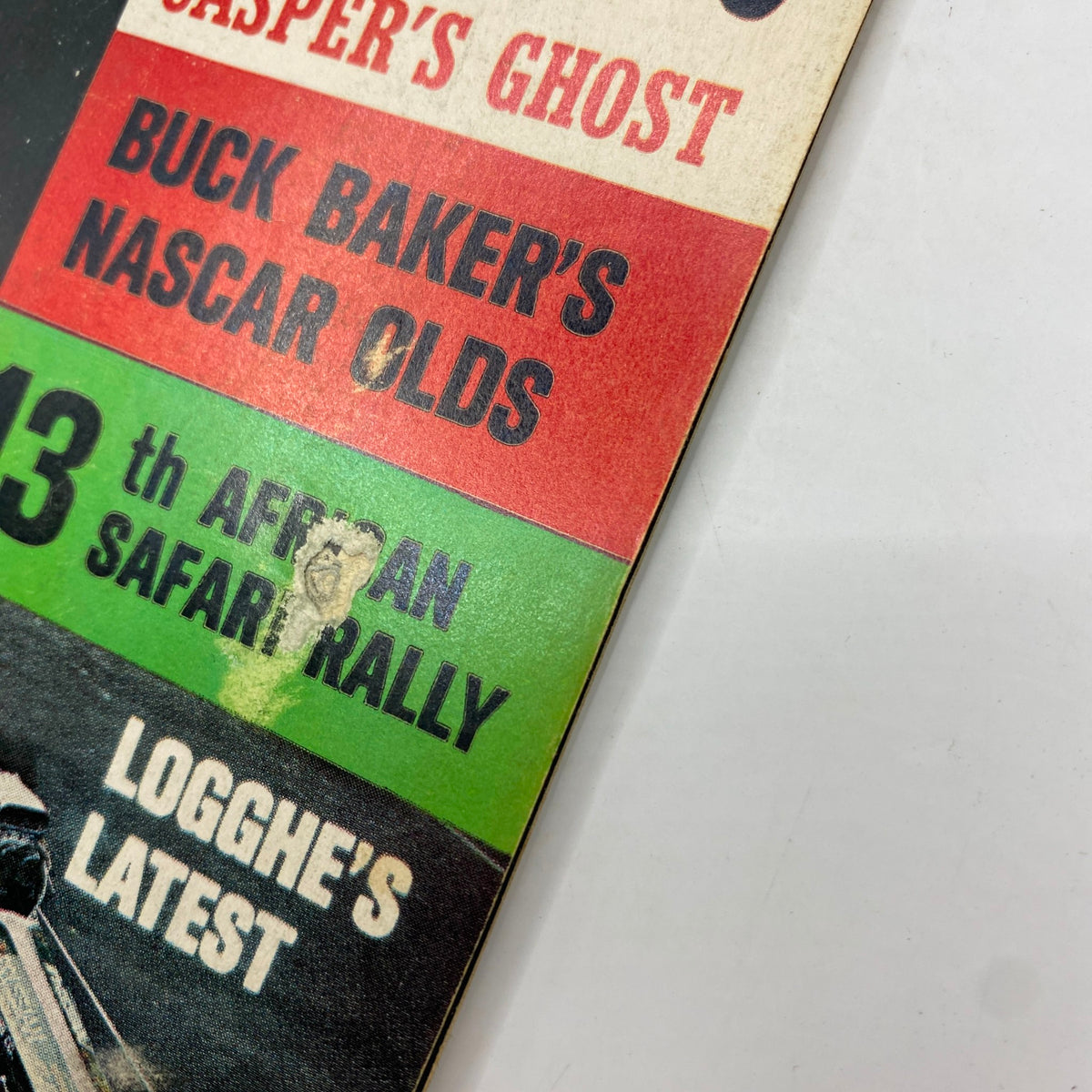 Close-up of the spine of the December 1965 American Rodding Magazine, detailing features including Buck Baker's NASCAR Olds.