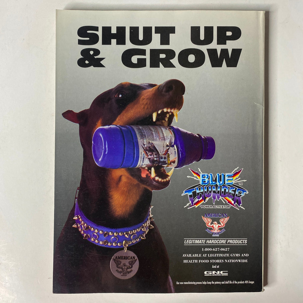 Advertisement titled "Shut Up & Grow" featuring a dog holding a blue canister, from the MuscleMag International Magazine September 1995 #159.