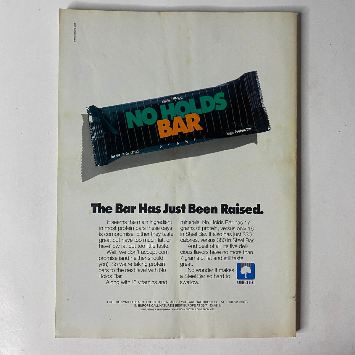 Back cover of MuscleMag International Magazine December 1996 advertising a high-protein snack bar, emphasizing health and nutrition.