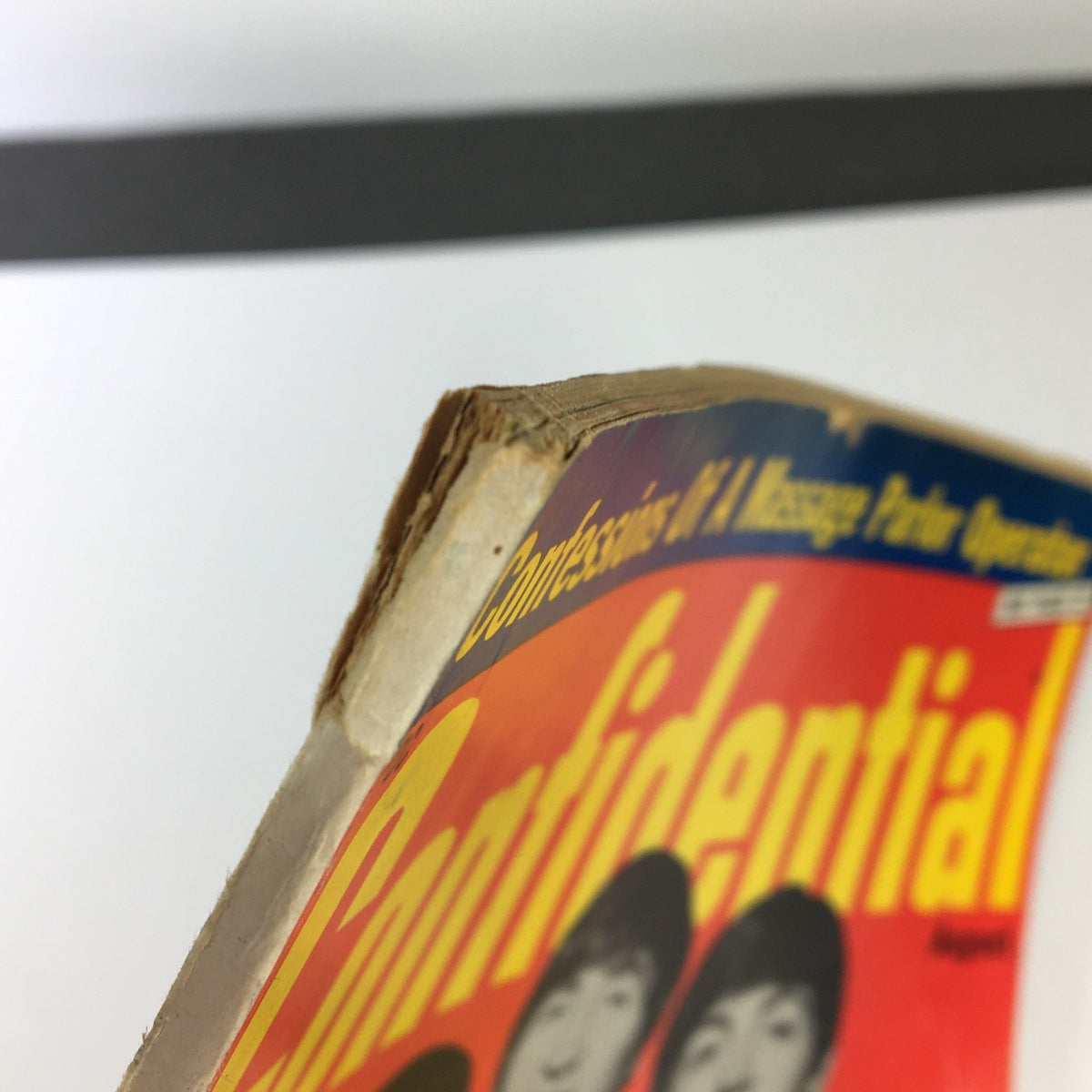 Close-up view of the top edge of VTG Confidential Magazine August 1964, highlighting some wear and the vibrant cover design with The Beatles.