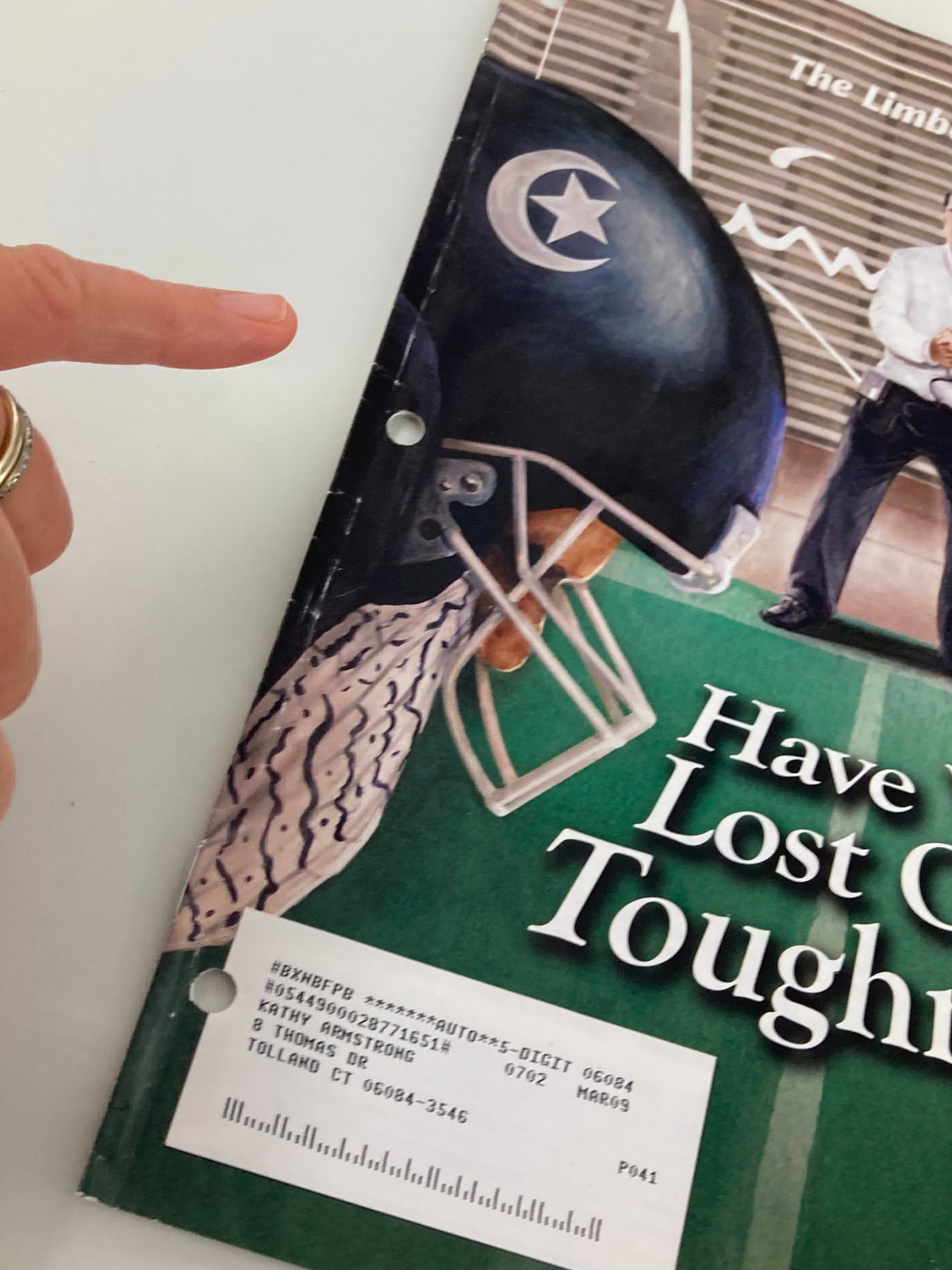 Close-up of the 'Rush Limbaugh Letter Newsletter February 2007' highlighting the cover's corner with a pointer finger, showing the title 'Have We Lost Our Toughness?'