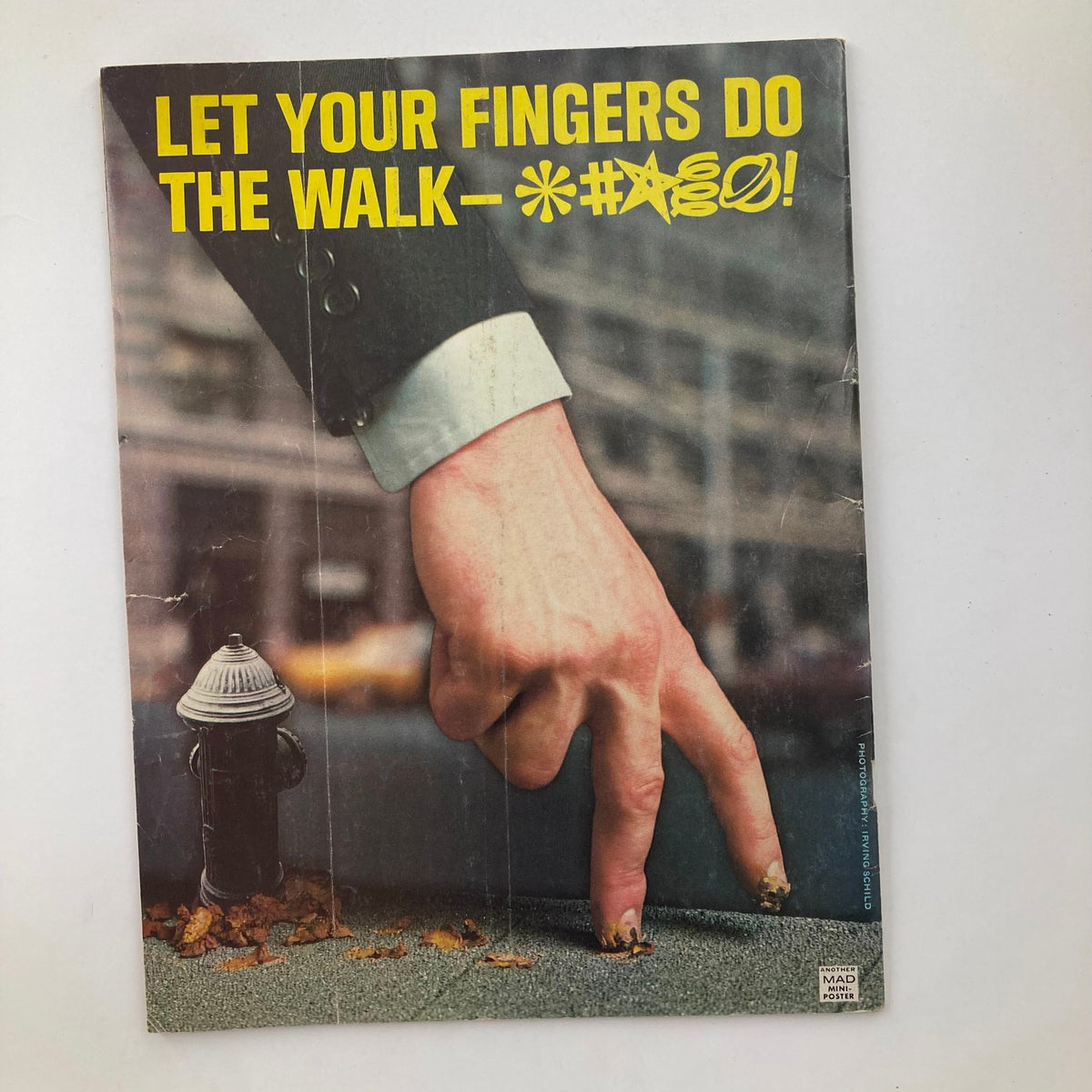 Back cover of Mad Magazine July 1976 No. 184 with a bold graphic saying 'LET YOUR FINGERS DO THE WALK-' showcasing the magazine's satirical style.