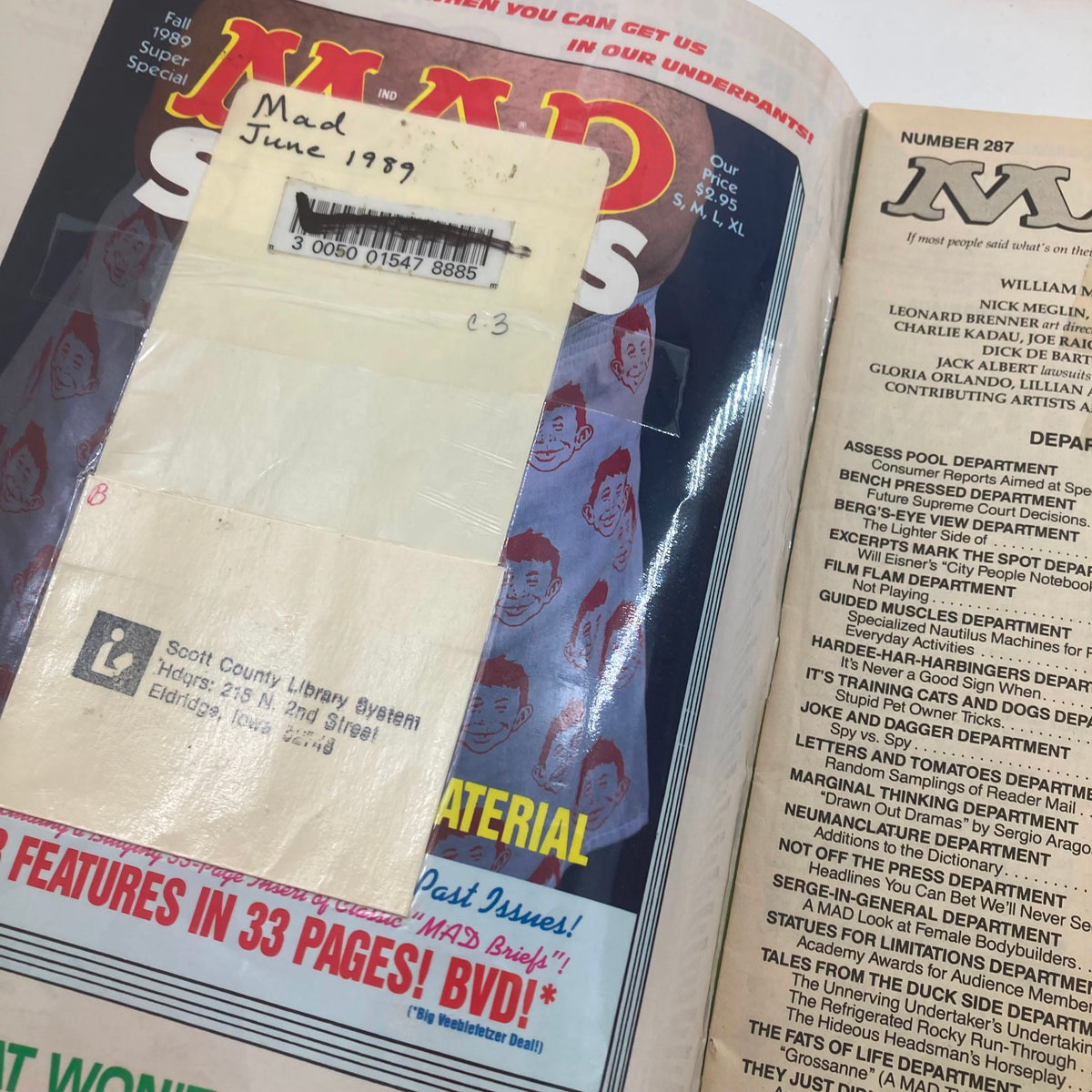 Another inside view of Mad Magazine June 1989 No. 287 showing the inside cover with library markings and a colorful design.