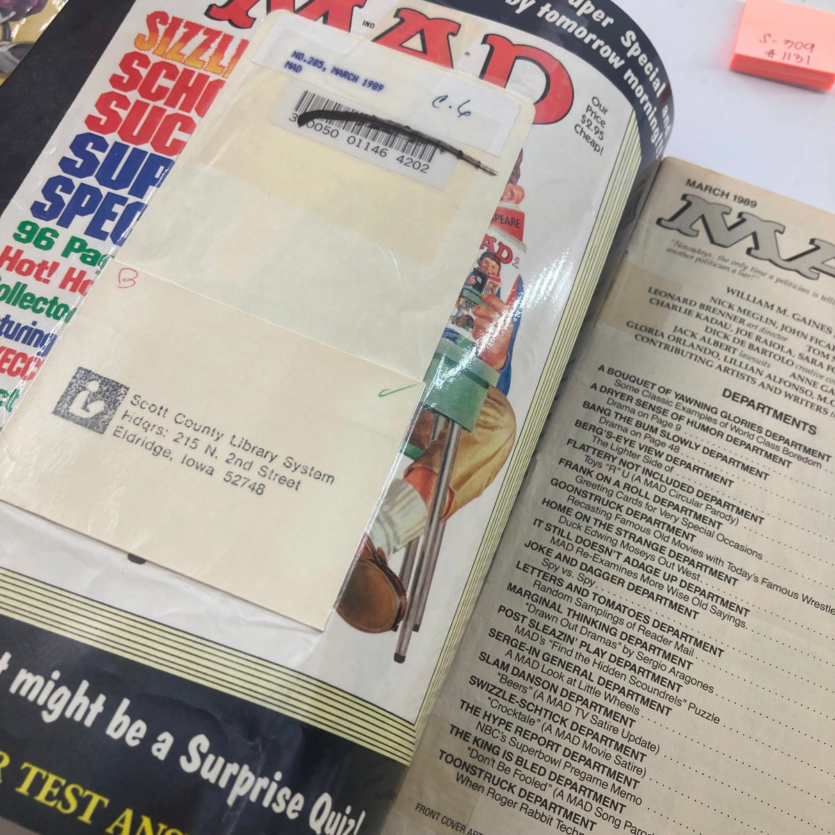 Interior view of Mad Magazine March 1989 No. 285 showing pages and a library card, highlighting the vintage condition and collectible nature of the magazine.