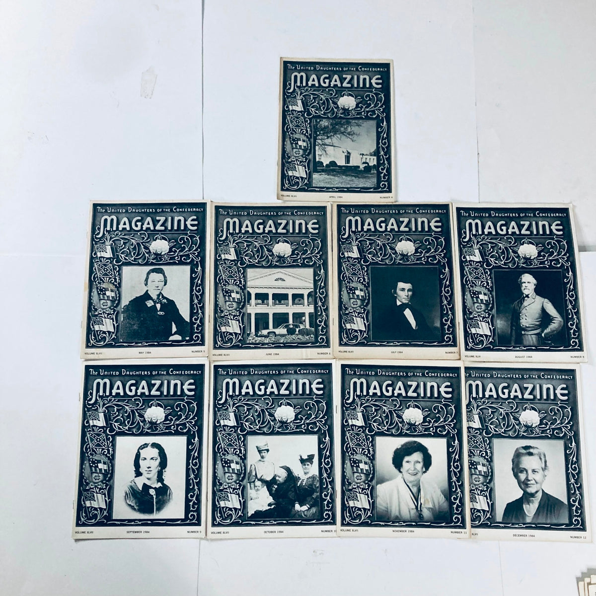 Nine vintage issues of The United Daughters of The Confederacy Magazine arranged artistically, showcasing highlights of Southern history and culture.