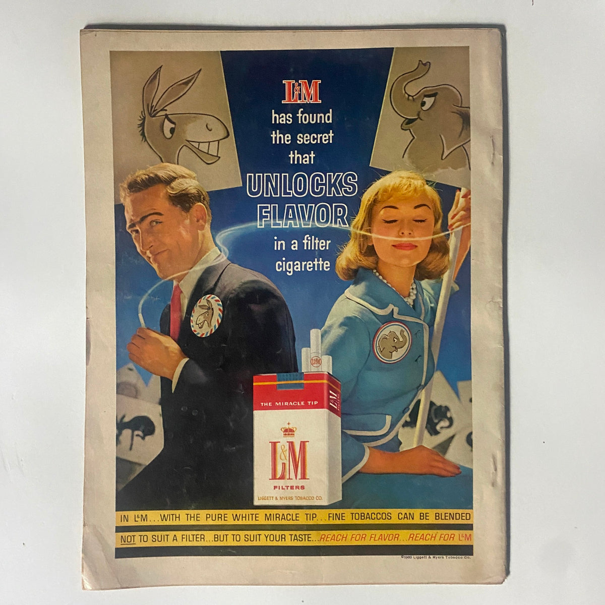 Advertisement found in VTG Motor Trend Magazine September 1960 promoting L&M Filters cigarettes, featuring a stylish man and woman, adding a glimpse of advertising trends during the early 1960s.