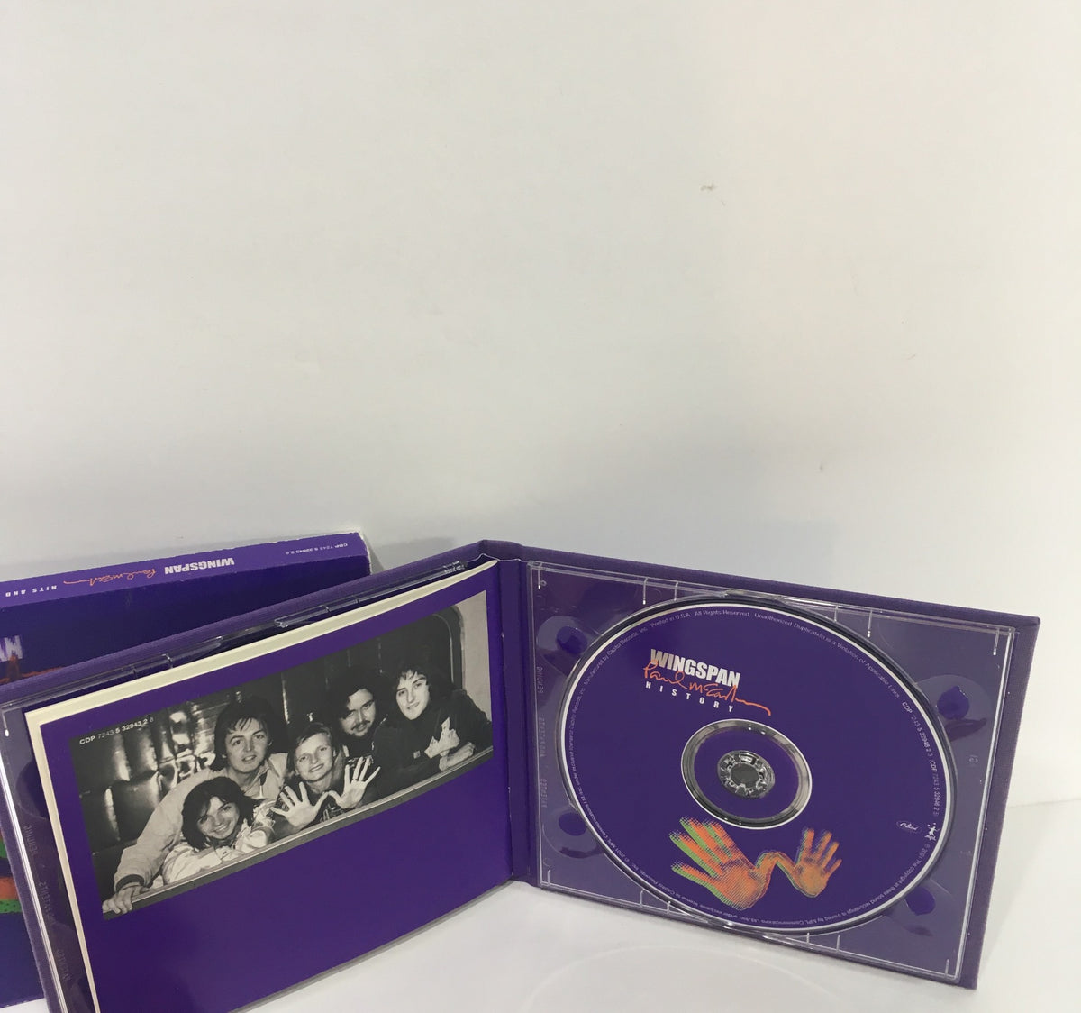 Inside of Paul McCartney Wingspan Hits and History Audio CD showing the disc and band photo.