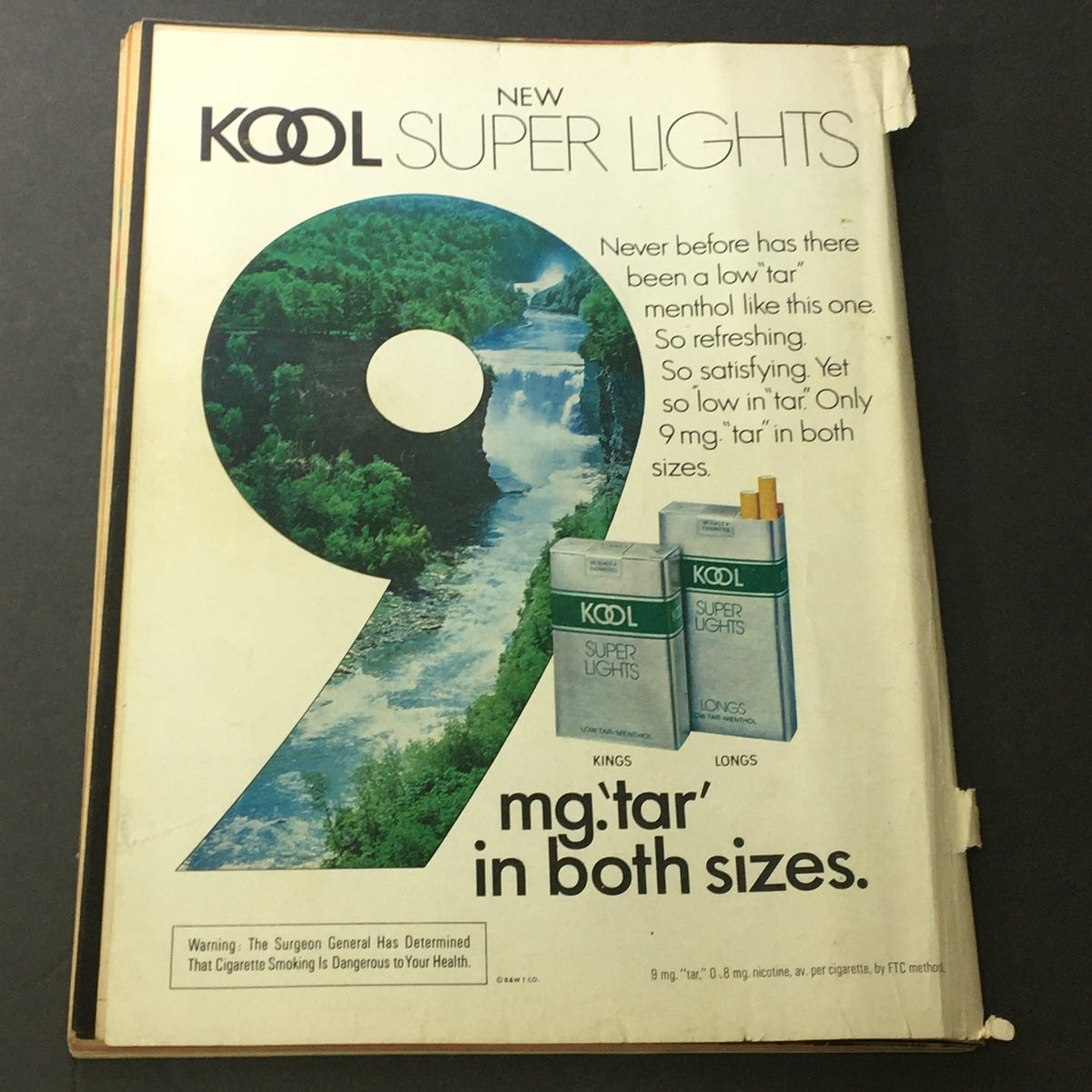 Back cover of The National Lampoon Humor Magazine October 1977 Edition featuring The Beatles, showcasing an advertisement for Kool Super Lights cigarettes with a scenic waterfall and the text highlighting low tar content.