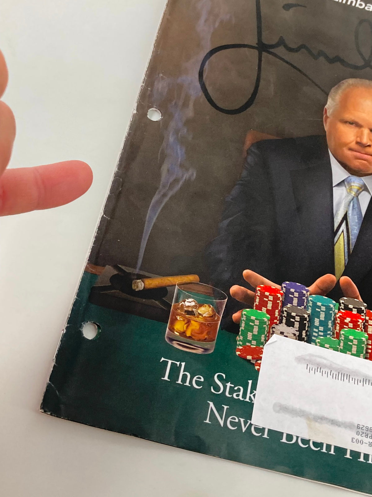 Close-up of the cover of the Rush Limbaugh Letter Newsletter Magazine from July 2019 titled 'The Stakes for America'. The image shows detail of Limbaugh with a drink and poker chips, emphasizing themes of risk in political discourse.