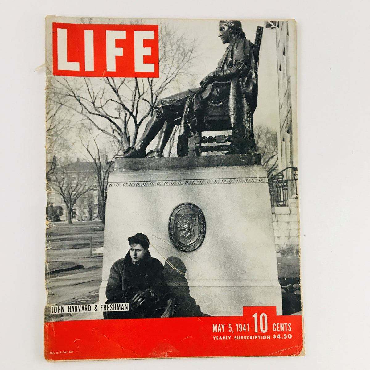 Cover of VTG Life Magazine May 5 1941 featuring John Harvard & Freshman photograph, showcasing a young man sitting near a statue of John Harvard with trees in the background.