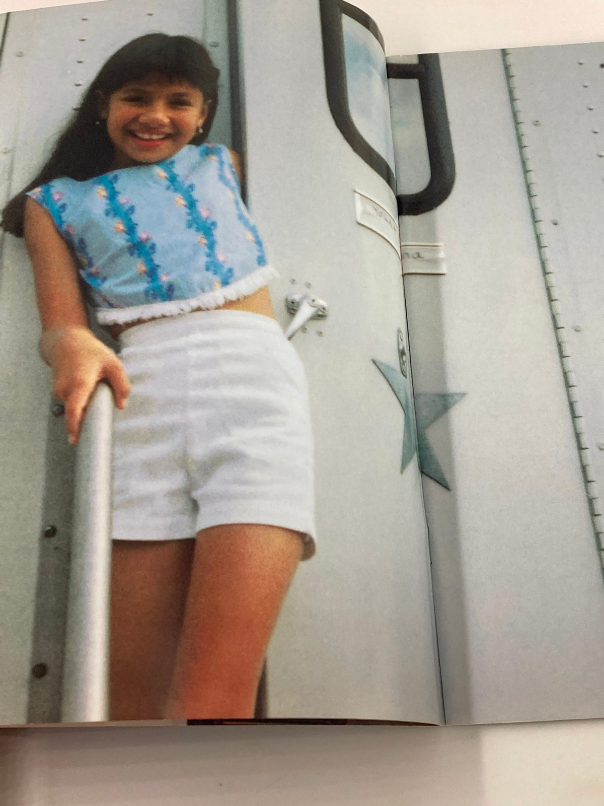 Image from the 1997 Selena Movie Special Movie Showcase Series displaying Becky Lee Meza smiling, dressed in a stylish outfit, captured while posing outdoors.
