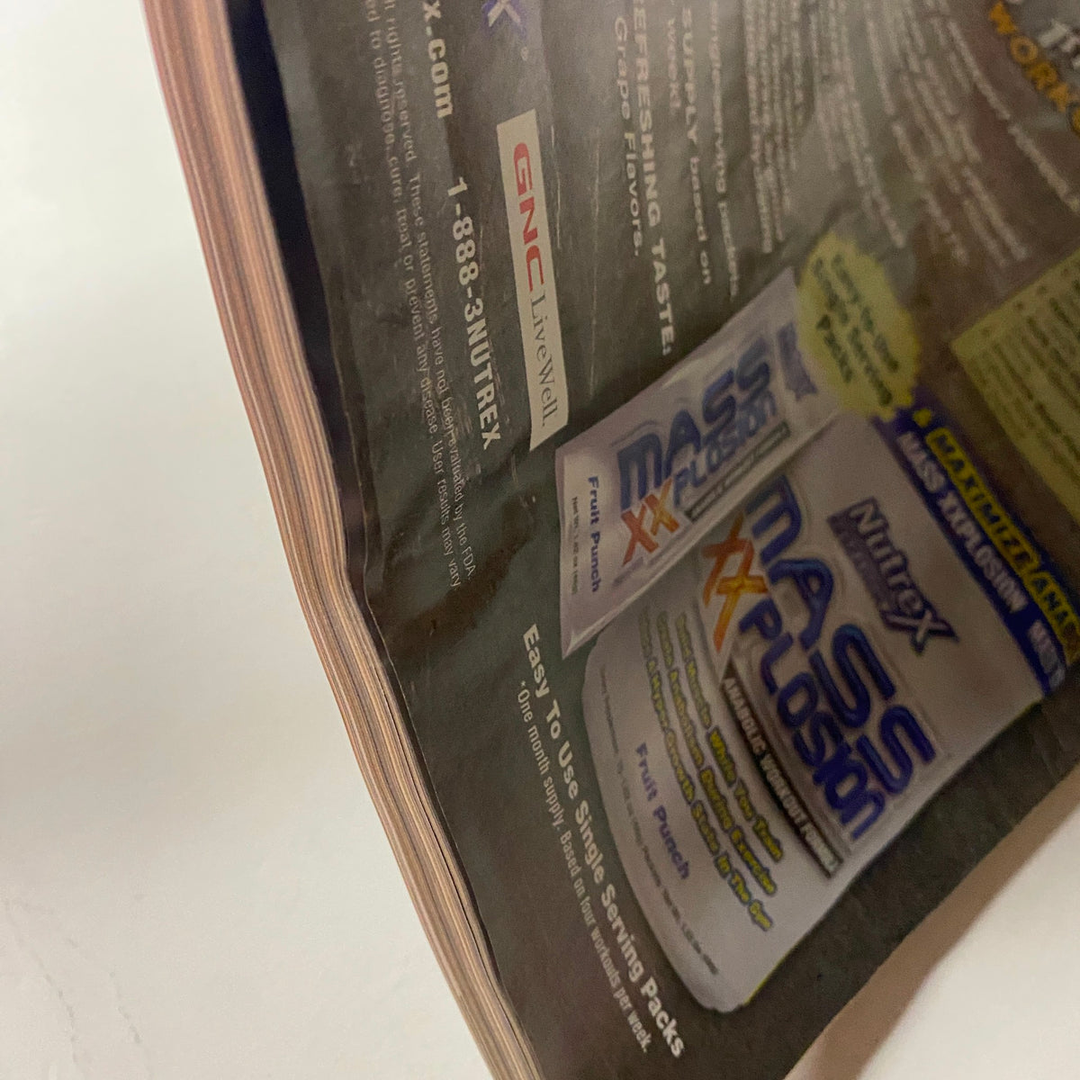 MuscleMag International Magazine August 2008 #315 advertising page showing GNC Mass Plosion product with visible page wear.