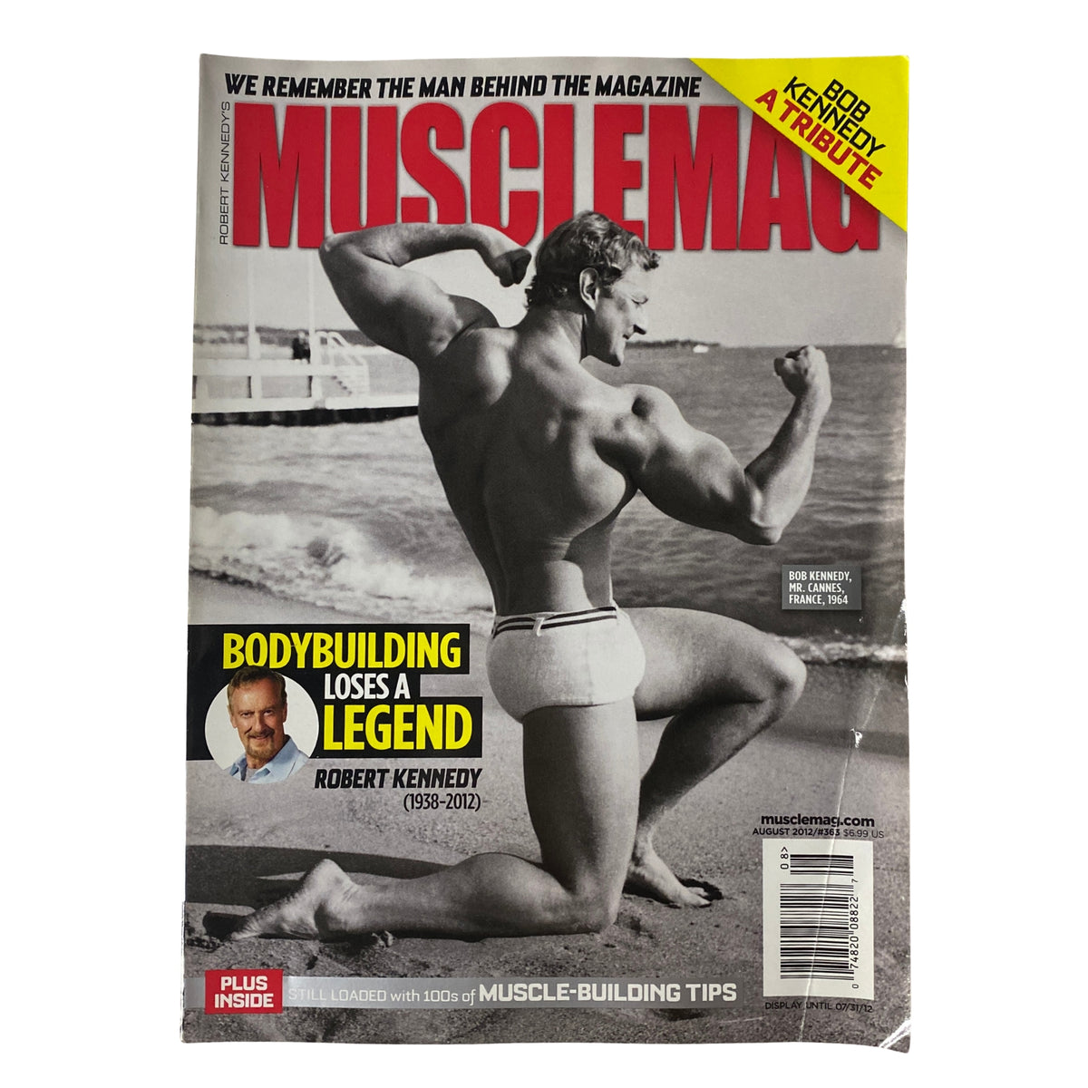 Cover of MuscleMag International Magazine August 2012 #363 featuring a tribute to Robert Kennedy, showcasing a muscular man on the beach with bold headlines.