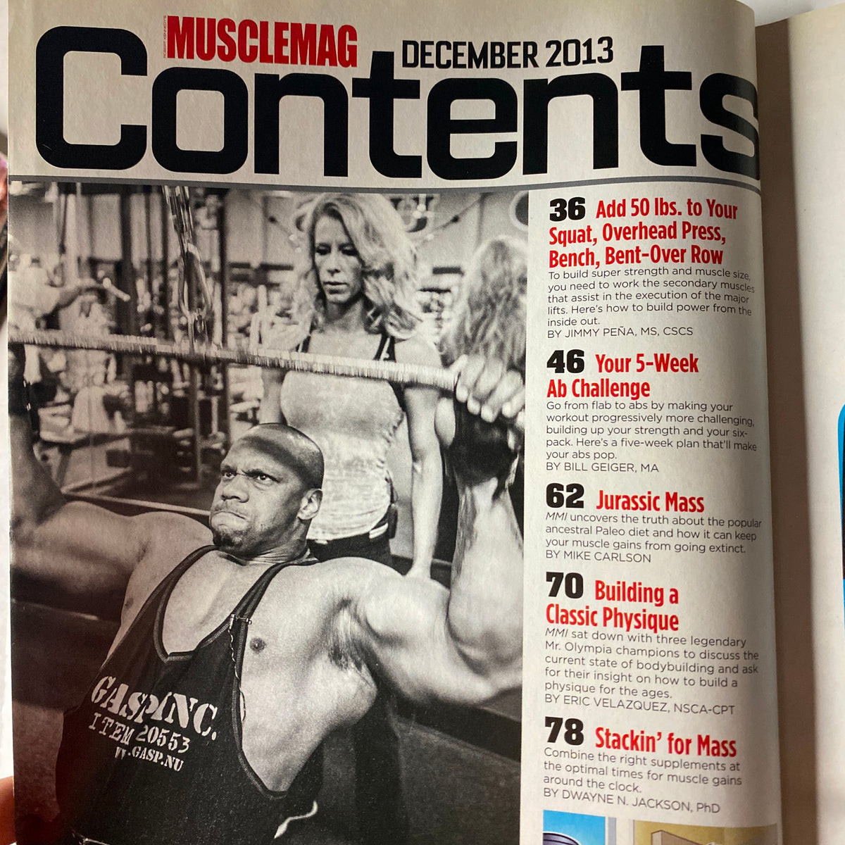 Table of contents from MuscleMag International Magazine December 2013, listing articles on fitness and bodybuilding, including a five-week ab challenge and building classic physique. Title: MuscleMag International Magazine December 2013 Larry Vinette No Label VG.