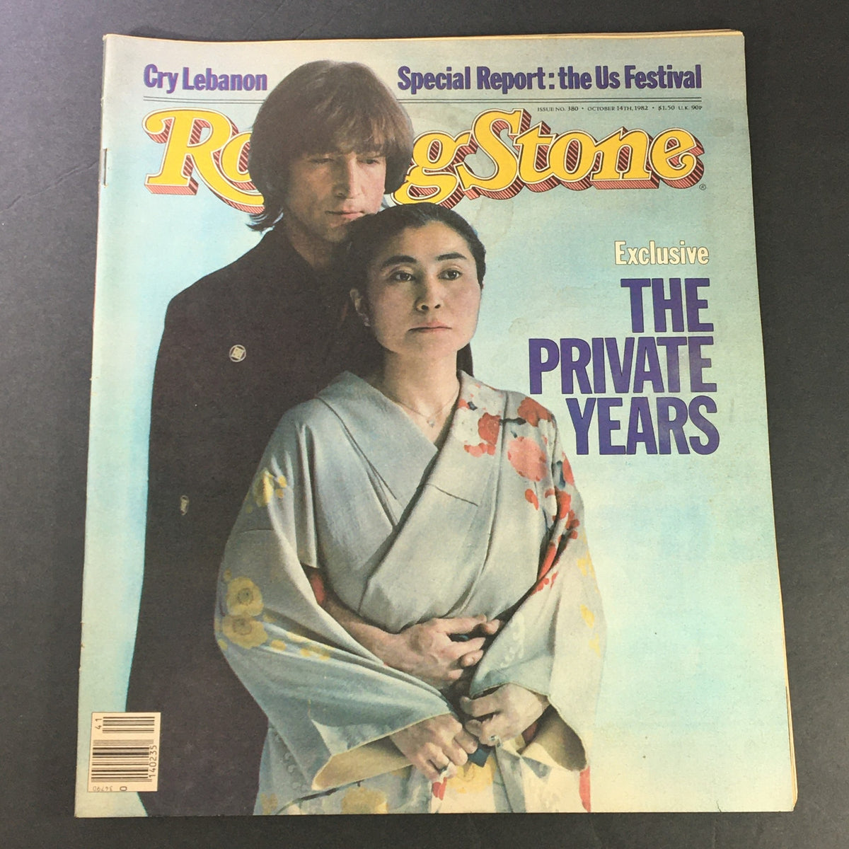 Vintage Rolling Stone Magazine cover from October 14, 1982, issue number 380 featuring John Lennon and Yoko Ono. The iconic duo is depicted with Lennon's serious expression and Yoko's traditional kimono attire, emphasizing their influence in rock and roll history. Perfect for music collectors.