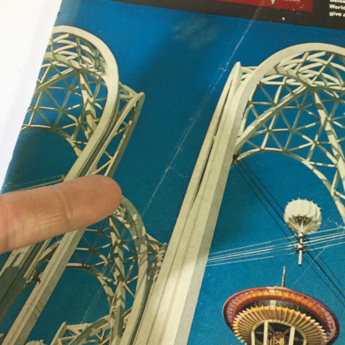 Detail view of VTG Business Week Magazine April 21 1962 display with fingers pointing at the architectural elements related to the Seattle World's Fair.