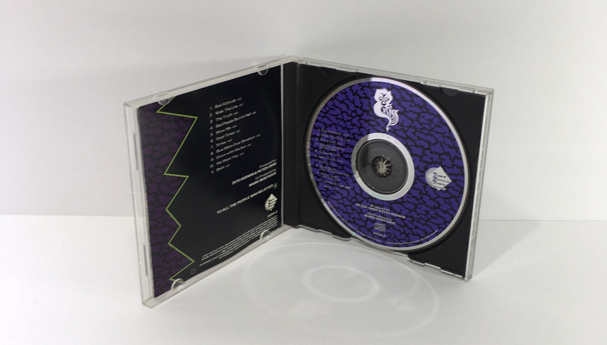 Interior view of Peter Criss: Criss Cat #1 Audio CD showing the disc design with a purple background and track listing, highlighting the collectible nature of the product.