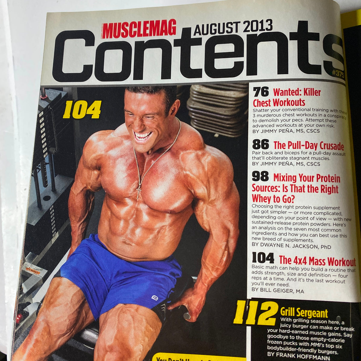 MuscleMag International Magazine August 2013 cover with contents overview featuring fitness articles and workouts, including 'Killer Chest Workouts' and 'The Poll-Day Crusade'.