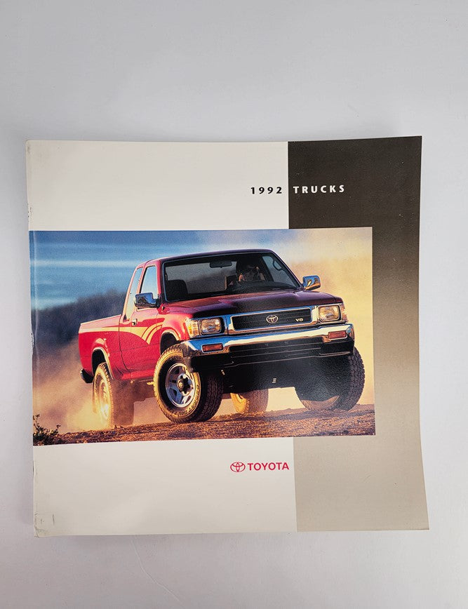 1992 Toyota Trucks mid-size T100 Car Sale Brochure Catalog showcasing the exterior of a red Toyota truck in a natural landscape setting.