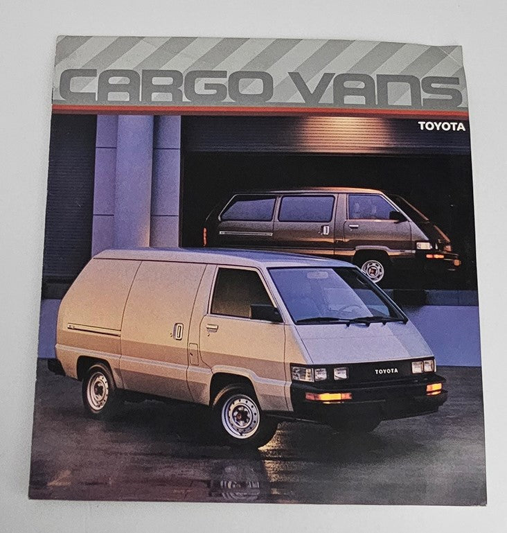 Cover of the 1986 Toyota Cargo Vans Dealer Showroom Sales Brochure Guide Catalog featuring two Toyota cargo vans with modern design in a showroom setting.