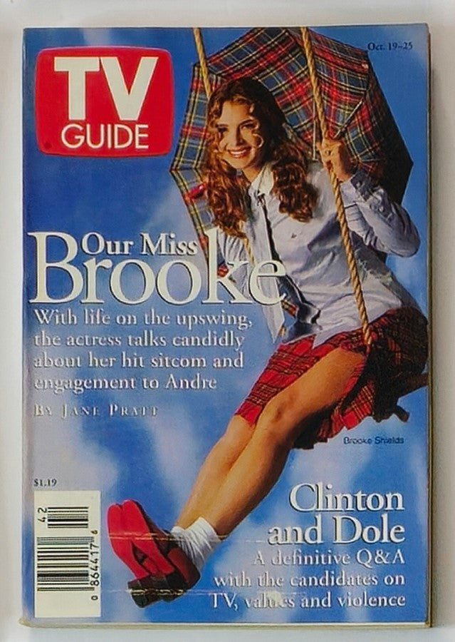 TV Guide Magazine cover featuring Brooke Shields from October 19, 1997. The image shows Brooke in a playful pose, swinging with an umbrella, wearing a plaid skirt and looking cheerful. This New York Metro Edition highlights her interview about her hit sitcom and engagement.