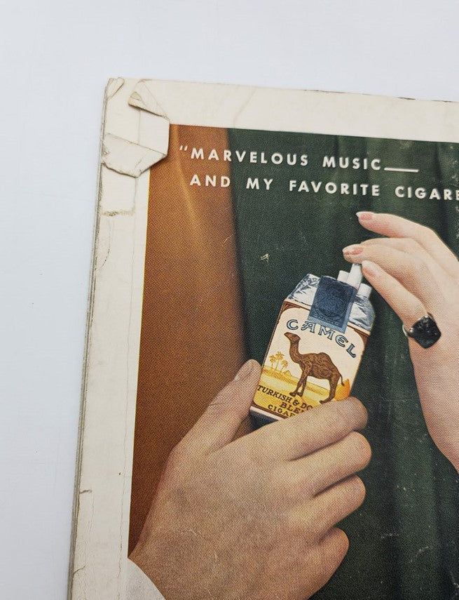 Close-up detail of the vintage House Beautiful magazine from August 1933, Volume 74, Issue #2, focusing on an advertisement featuring Camel cigarettes, showcasing the nostalgic design elements of the era.