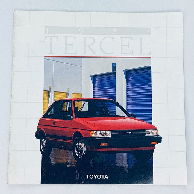 Cover of the 1987 Toyota Tercel Dealer Showroom Sales Brochure Guide Catalog featuring a red Toyota Tercel car parked in front of a stylish showroom with modern aesthetics.