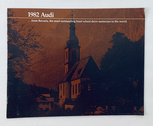 1982 Audi Bavaria Car Dealer Showroom Sales Brochure featuring a scenic Bavarian church, highlighting the outstanding front-wheel-drive motorcars from Audi.