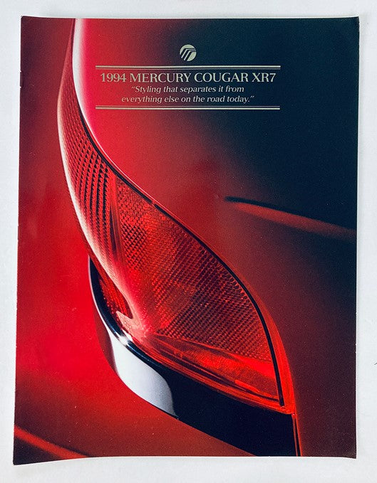 Close-up image of the rear taillight of a 1994 Mercury Cougar XR7, highlighting its sleek design and styling that separates it from everything else on the road today, as featured in the dealer showroom sales brochure.
