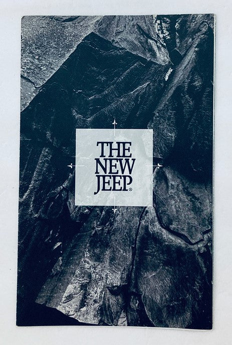 Cover of the 80s 90s Jeep Dealer Showroom Sales Brochure Guide Catalog featuring bold text stating 'THE NEW JEEP' against a dark rocky background.