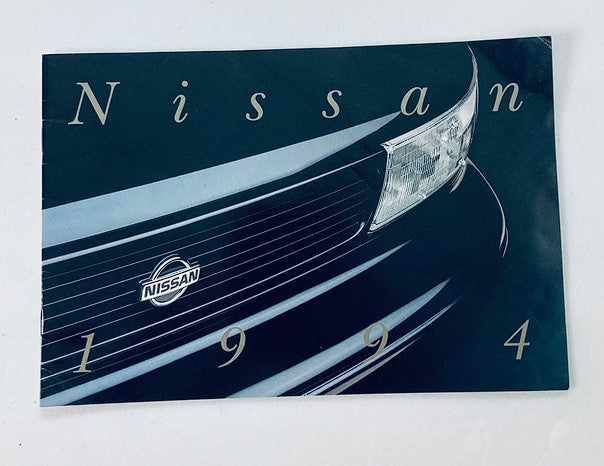 1994 Nissan Dealer Showroom Sales Brochure Guide Catalog featuring a close-up of a Nissan vehicle's front grille and logo, ideal for collectors and automotive enthusiasts.