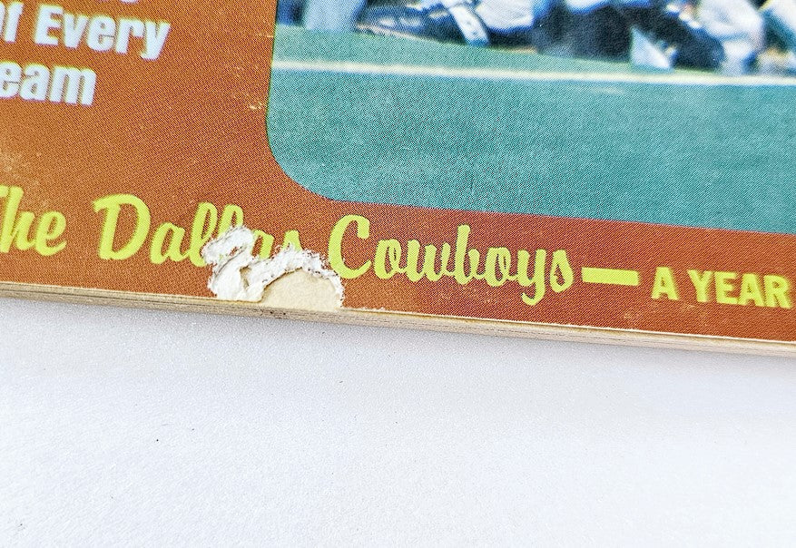 Close-up view of a vintage Football Digest magazine from August 1973 featuring O.J. Simpson, highlighting the faded cover art with a minor tear on the edge that includes text about the Dallas Cowboys.