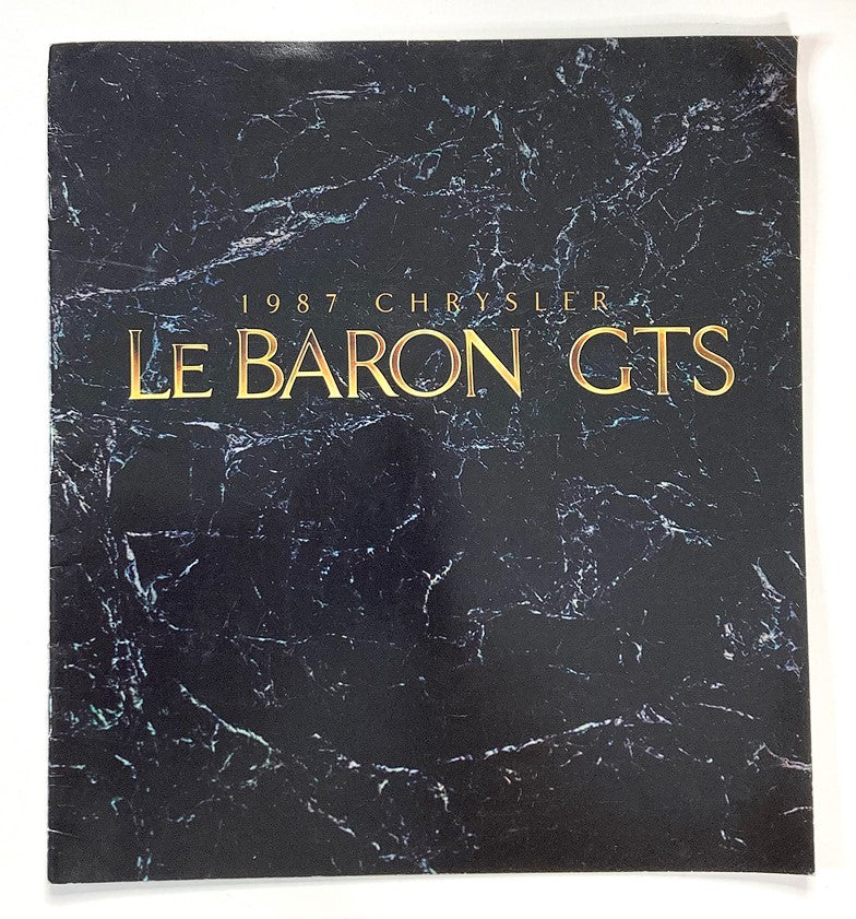 Cover of the 1987 Chrysler LeBaron GTS Dealer Showroom Sales Brochure Guide Catalog featuring a marbled background with gold lettering.