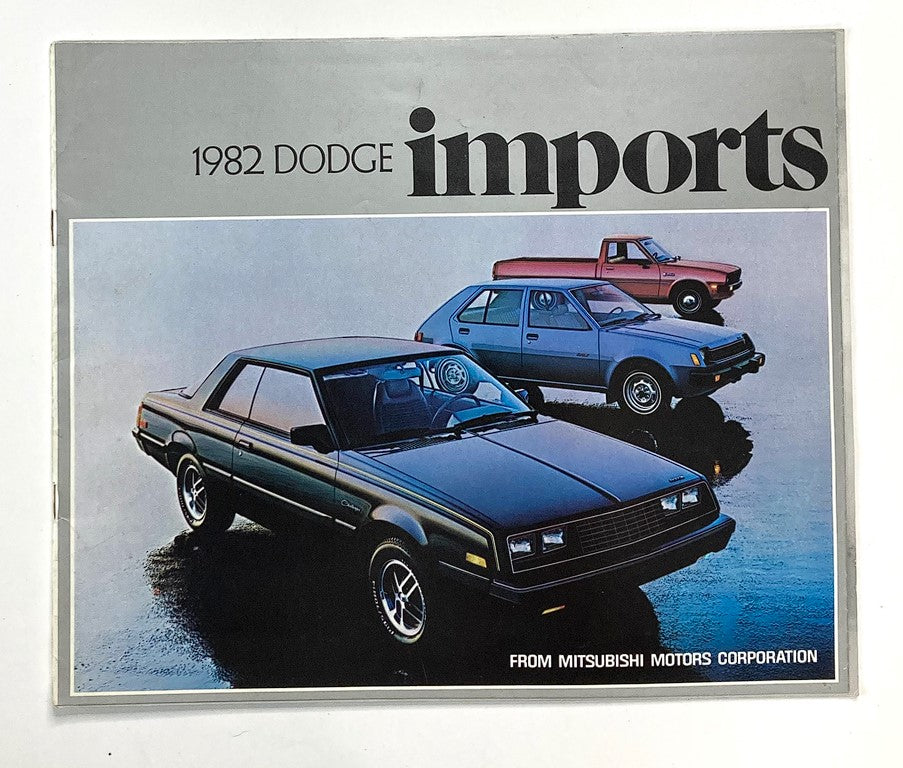 1982 Dodge Imports Dealer Showroom Sales Brochure featuring three models including a black car in the foreground and two additional cars in the background, representing Dodge's offerings for the year.