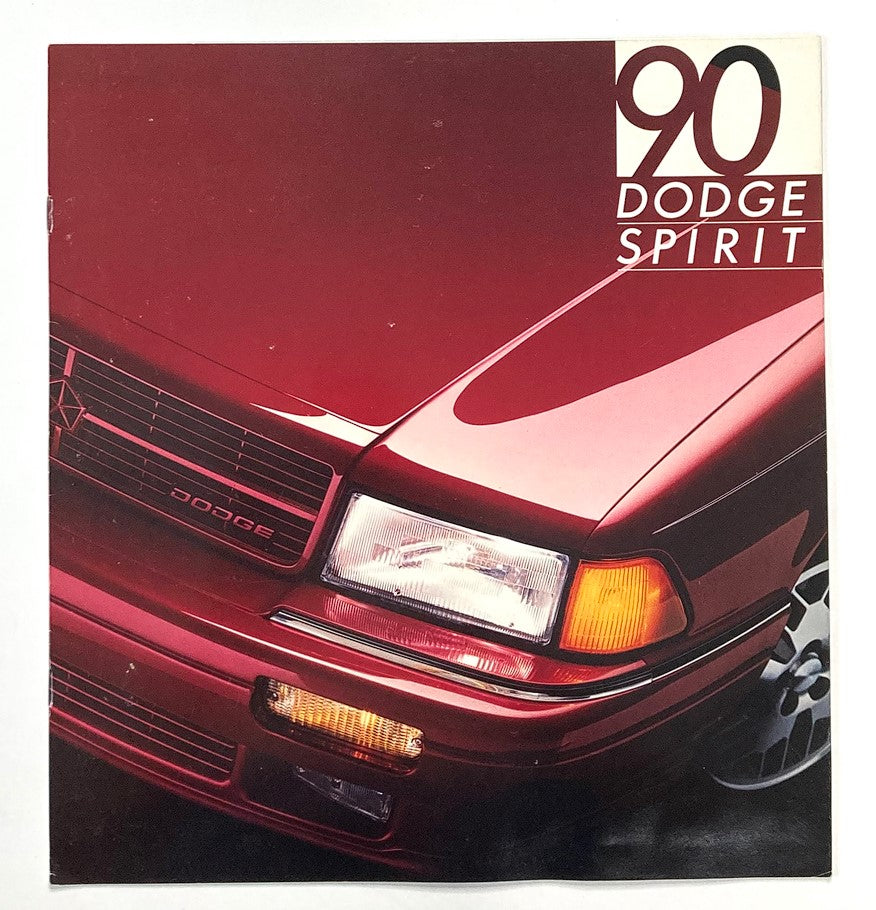 Cover image of the 1990 Dodge Spirit Dealer Showroom Sales Brochure Guide Catalog showcasing the front grille and headlights of the red Dodge Spirit.