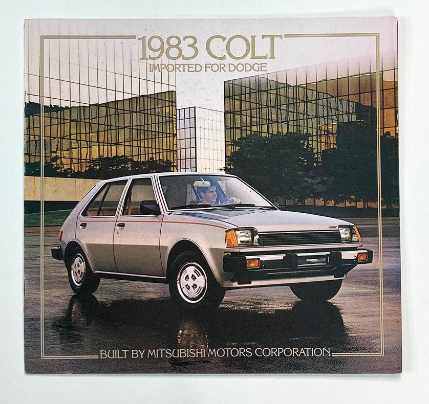 1983 Colt Imported for Dodge Dealer Showroom Sales Brochure Guide Catalog featuring a front view of a silver Colt car parked in an urban setting with a modern building backdrop. Built by Mitsubishi Motors Corporation.