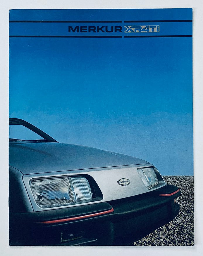 1985 Merkur XR4Ti Dealer Showroom Sales Brochure Guide Catalog featuring a close-up of the car's front, showcasing its distinctive headlights and sleek design against a clear blue sky.
