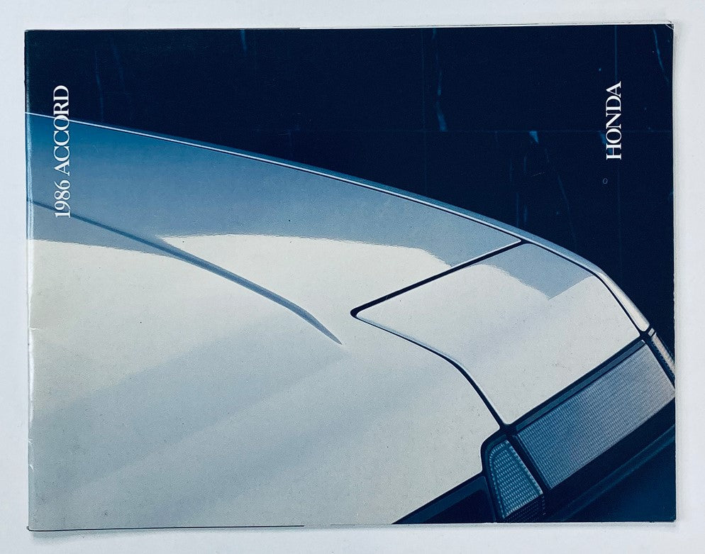 Cover image of the 1986 Honda Accord Dealer Showroom Sales Brochure Guide Catalog, showcasing the sleek design of the car from an overhead perspective.