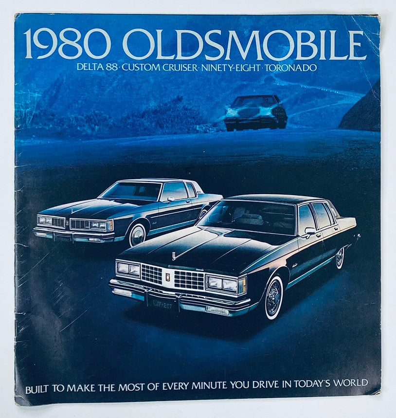 1980 Oldsmobile Delta-88 Dealer Showroom Sales Brochure featuring two classic Oldsmobile cars against a scenic background, highlighting the Delta 88, Custom Cruiser, Ninety-Eight, and Toronado models.