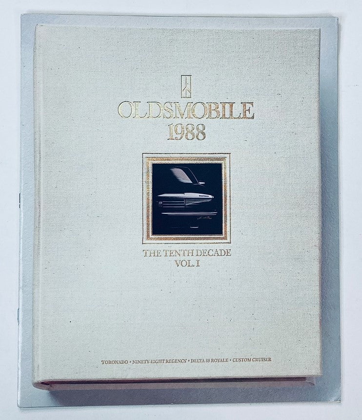 1988 Oldsmobile The 10th Decade Vol 1 Showroom Sales Brochure Guide Catalog cover featuring a sleek design with embossed lettering and a classic Oldsmobile logo.