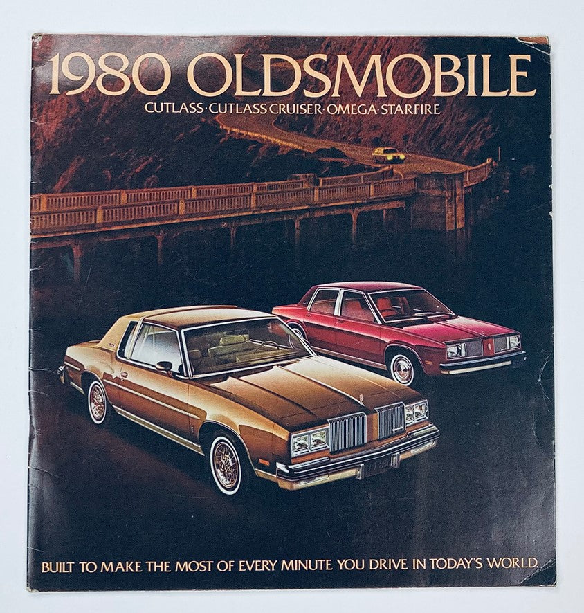Cover of the 1980 Oldsmobile Cutlass Cruiser Dealer Showroom Sales Brochure Guide Catalog, featuring a gold and red car parked in a scenic landscape, highlighting the appeal of Oldsmobile vehicles.