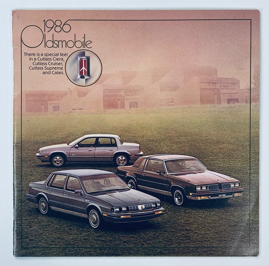 1986 Oldsmobile Cutlass Ciera Dealer Showroom Sales Brochure featuring three Oldsmobile models displayed in a scenic outdoor setting. Insight into the Cutlass Ciera, Cutlass Supreme, and Calais, showcasing their unique designs and features.
