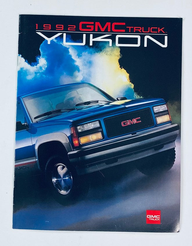 1992 GMC Truck Yukon Dealer Showroom Sales Brochure featuring a blue GMC Yukon against a dramatic cloudy backdrop, showcasing the vehicle design and branding.