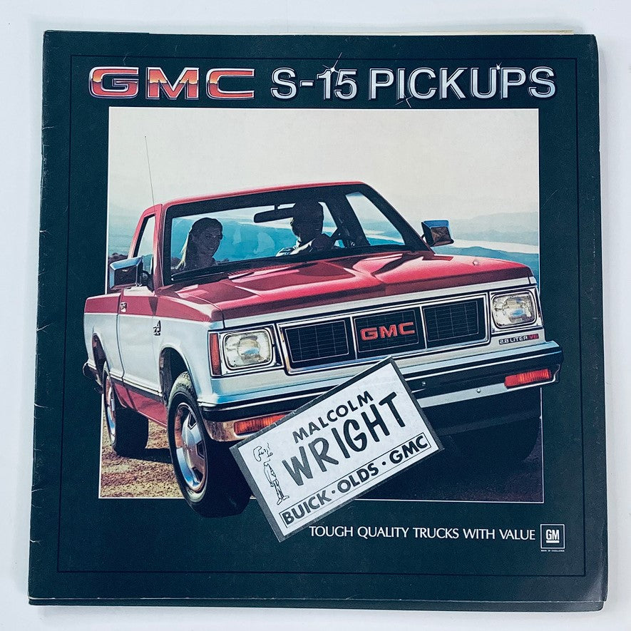 1984 GMC S-15 Pickups Trucks Dealer Showroom Sales Brochure showcasing a red GMC S-15 truck with two people inside, emphasizing tough quality trucks with value.