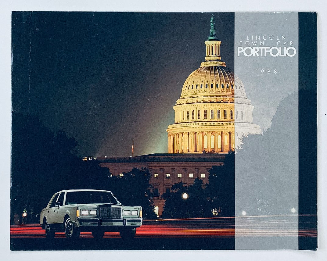 1988 Lincoln Town Car Portfolio Dealer Showroom Sales Brochure Guide Catalog featuring a classic Lincoln Town Car parked in front of the U.S. Capitol at night, highlighting the elegant design of the vehicle and the iconic architecture in the background.